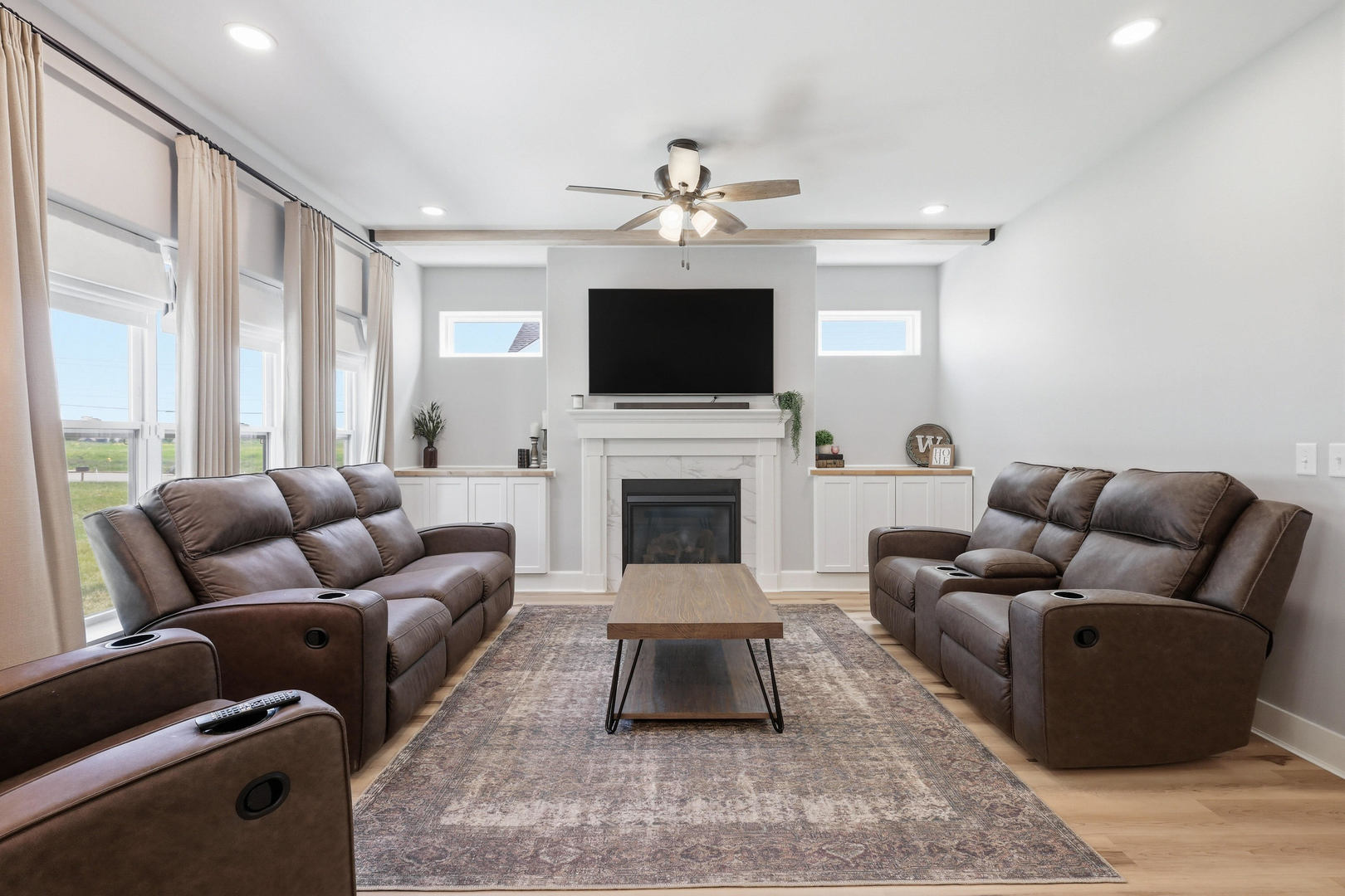 6779 Genesis Way Bettendorf, IA 52722 - Photo 11 of 36 a living room with furniture a flat screen tv and a fireplace