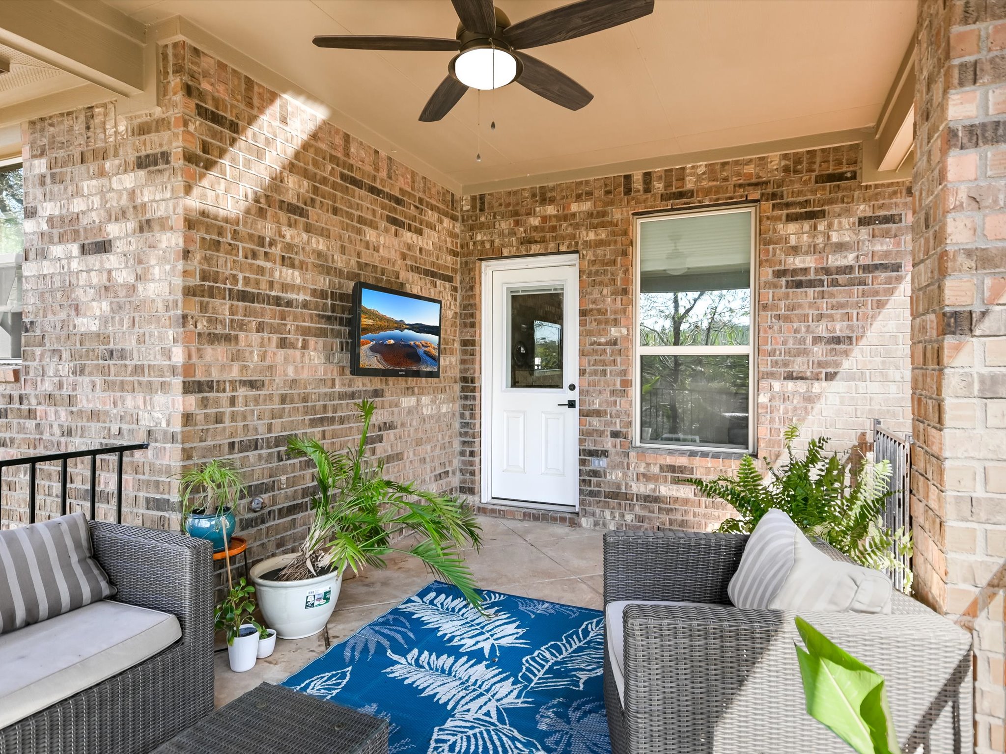 201 Bellagio Drive Austin, TX 78734 - Photo 27 of 31 The gorgeous covered back porch is an elevated, breezy outdoor retreat outfitted with a TV mount so you can grill out and catch the big game.