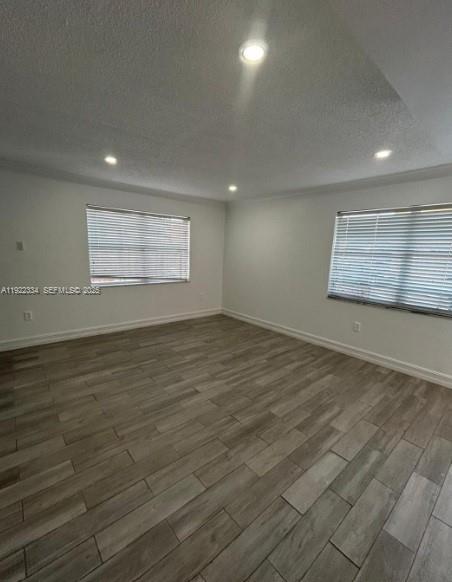 35 Northeast 12th Avenue, Unit 35 Homestead, FL 33030 - Photo 4 of 22 an empty room with wooden floor and windows