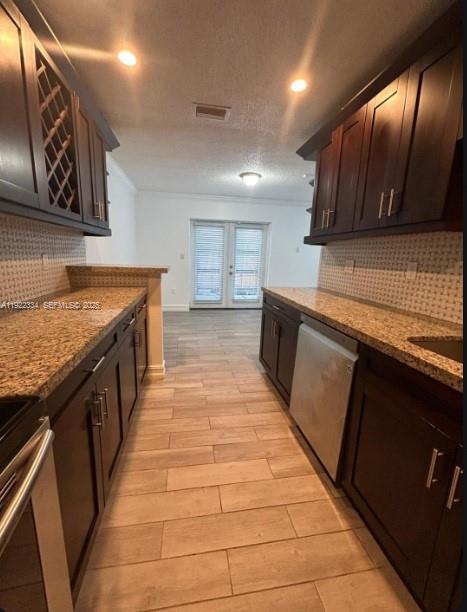 35 Northeast 12th Avenue, Unit 35 Homestead, FL 33030 - Photo 9 of 22 a large kitchen with stainless steel appliances granite countertop a stove a sink and a microwave