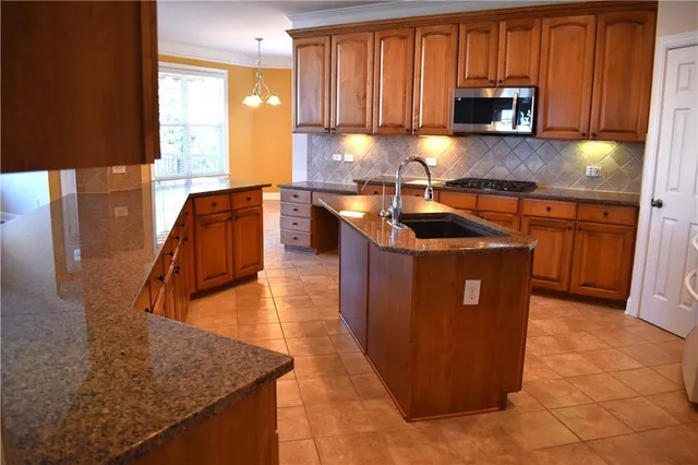 a kitchen with refrigerator and sink
