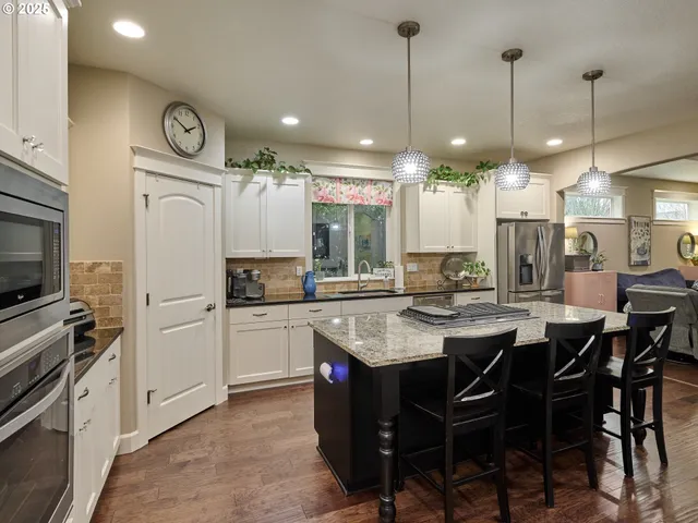 a kitchen with sink stove and refrigerator