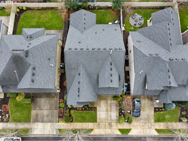 an aerial view of a city with lots of residential buildings ocean and mountain view