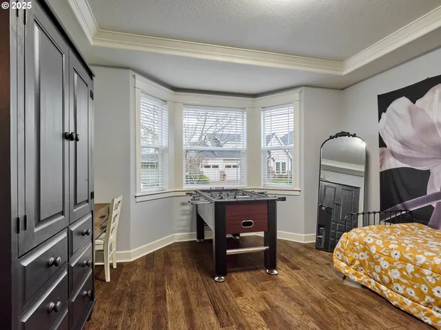 a living room with furniture a fireplace a flat screen tv and windows