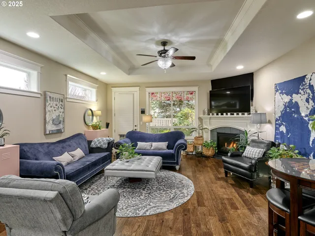 a living room with furniture a flat screen tv and a fireplace