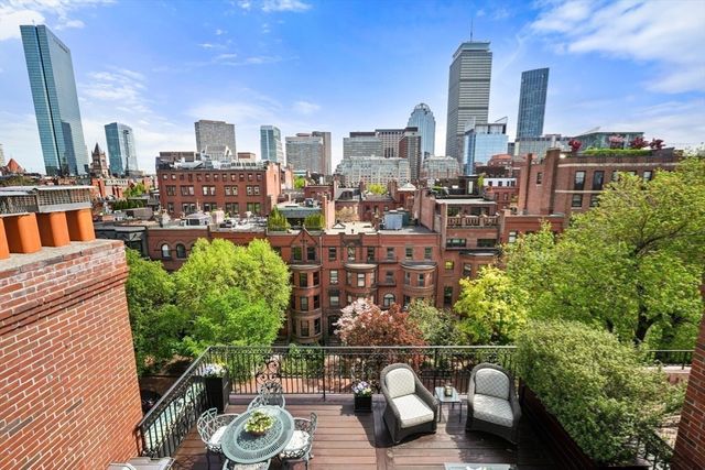 a view of a terrace with wooden benches