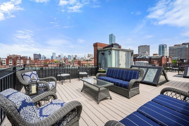 a living room with furniture a rug and a window