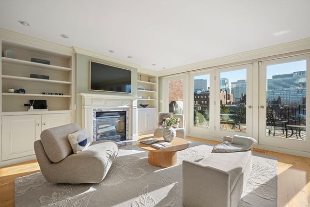 a living room with fireplace furniture and a flat screen tv