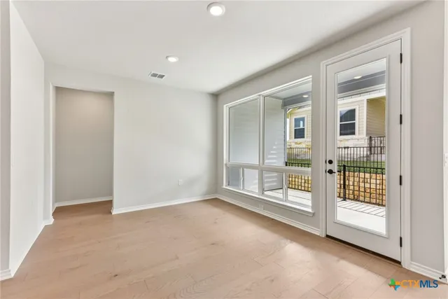 an empty room with sliding glass door and door