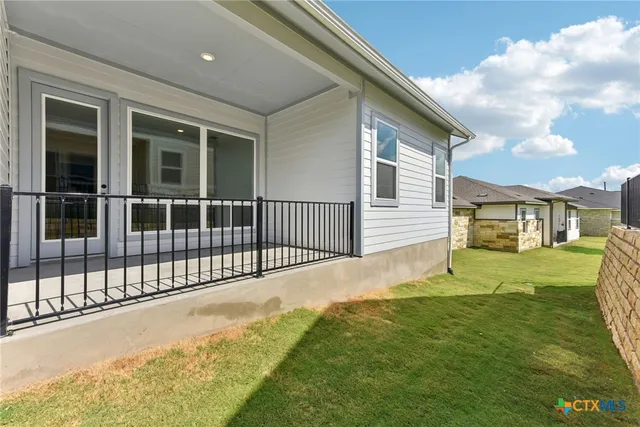 a view of a house with a yard and porch