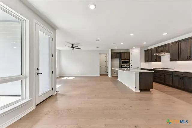 a large white kitchen with a large window