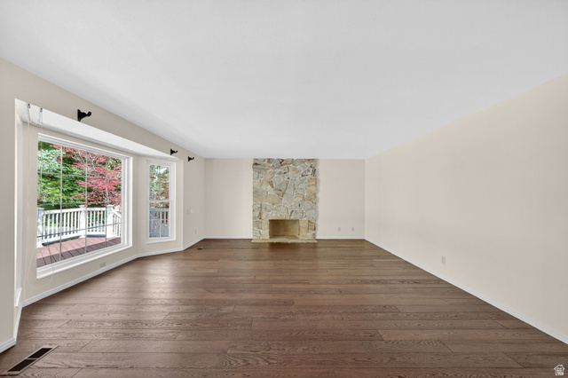 3120 North Apache Way Provo, UT 84604 - Photo 17 of 58 Expansive living area featuring rich wood-finish flooring and a prominent stone fireplace