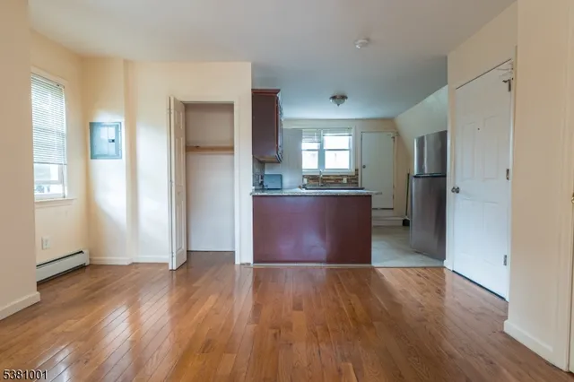 a view wooden kitchen with wooden floor and window