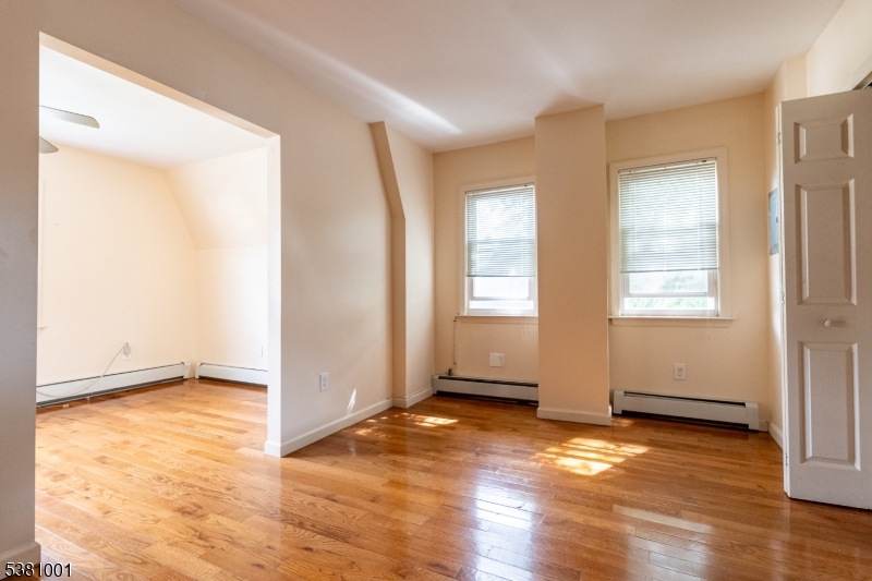 873 South 19th Street, Unit 3 Newark, NJ 07108 - Photo 10 of 10 an empty room with wooden floor and windows