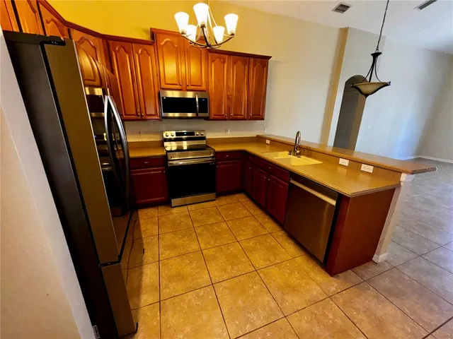 a kitchen with stainless steel appliances a sink stove and refrigerator