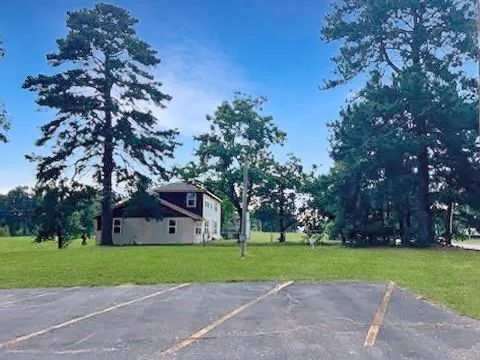 a front view of house with yard and green space