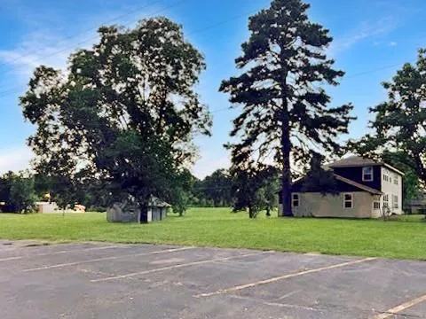 a view of a house with a tree in the yard