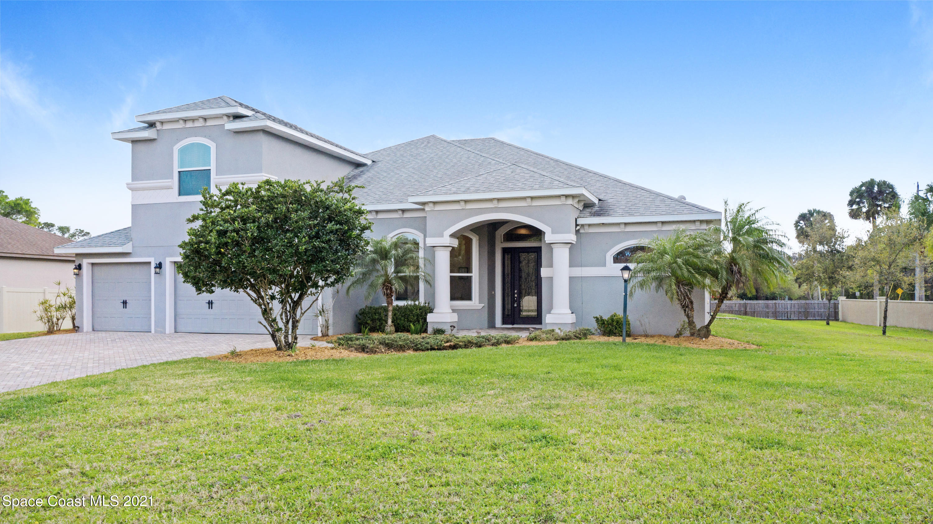 4108 Anlow Road Melbourne, FL 32904 - Photo 4 of 56 a front view of a house with a yard and garage
