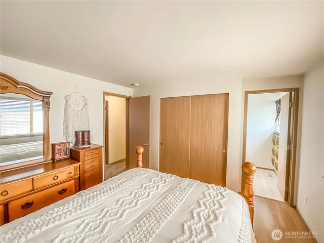 a bedroom with a bed and a large window