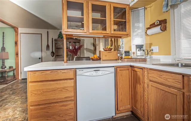 a kitchen with stainless steel appliances granite countertop a sink and cabinets