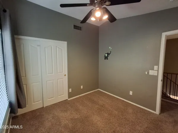 a view of a livingroom with a ceiling fan and window