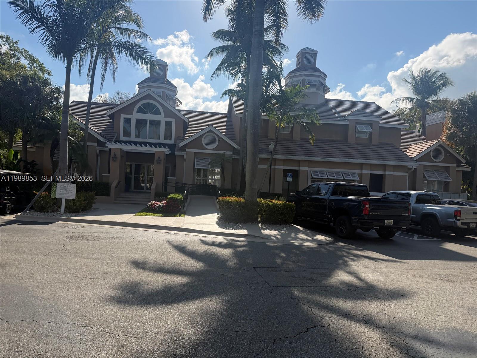 10670 Southwest 156th Place, Unit 308 Miami, FL 33196 - Photo 11 of 21 a front view of a house with yard and parking