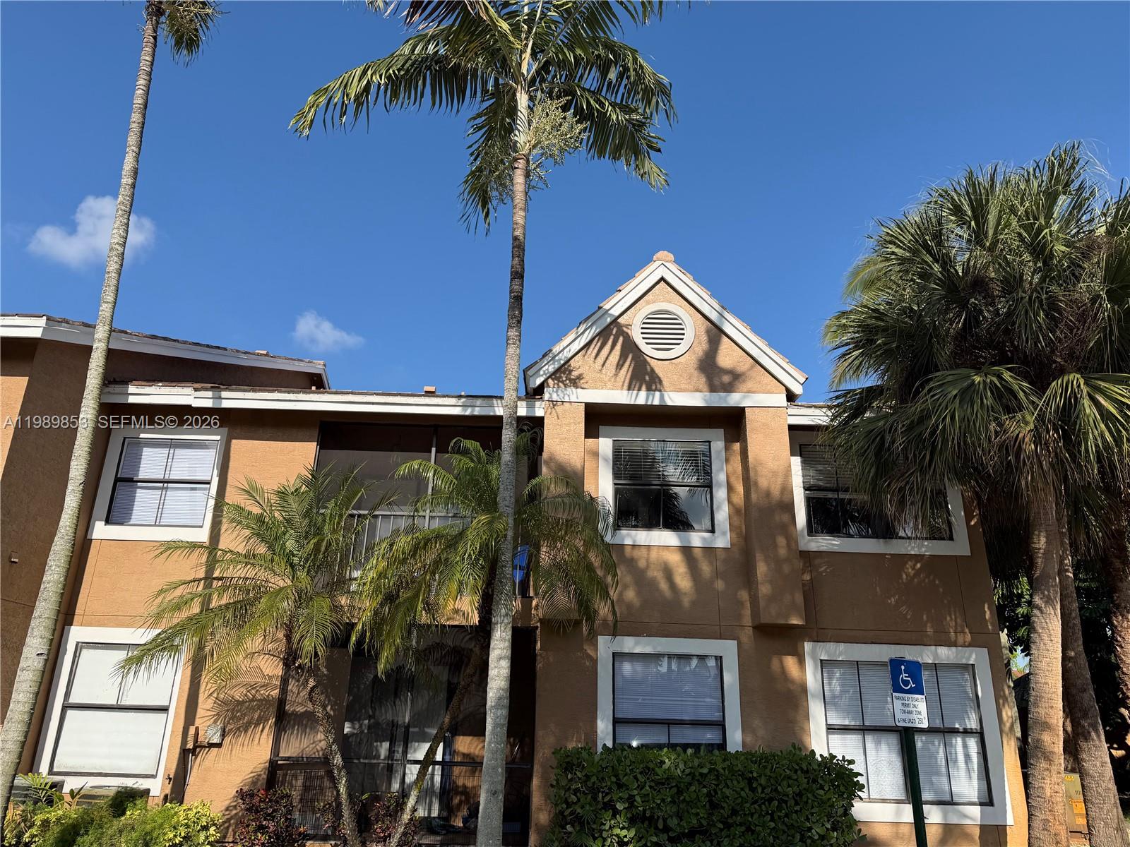 10670 Southwest 156th Place, Unit 308 Miami, FL 33196 - Photo 12 of 21 a front view of a house with a yard