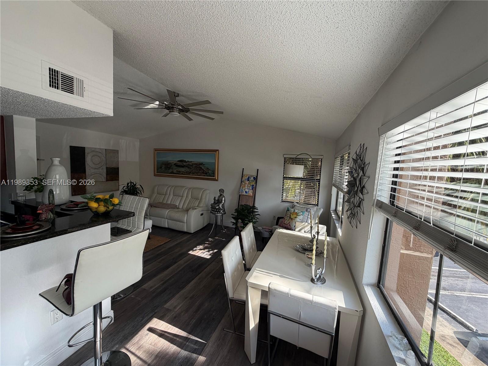 10670 Southwest 156th Place, Unit 308 Miami, FL 33196 - Photo 15 of 21 a view of a livingroom with furniture and a ceiling fan