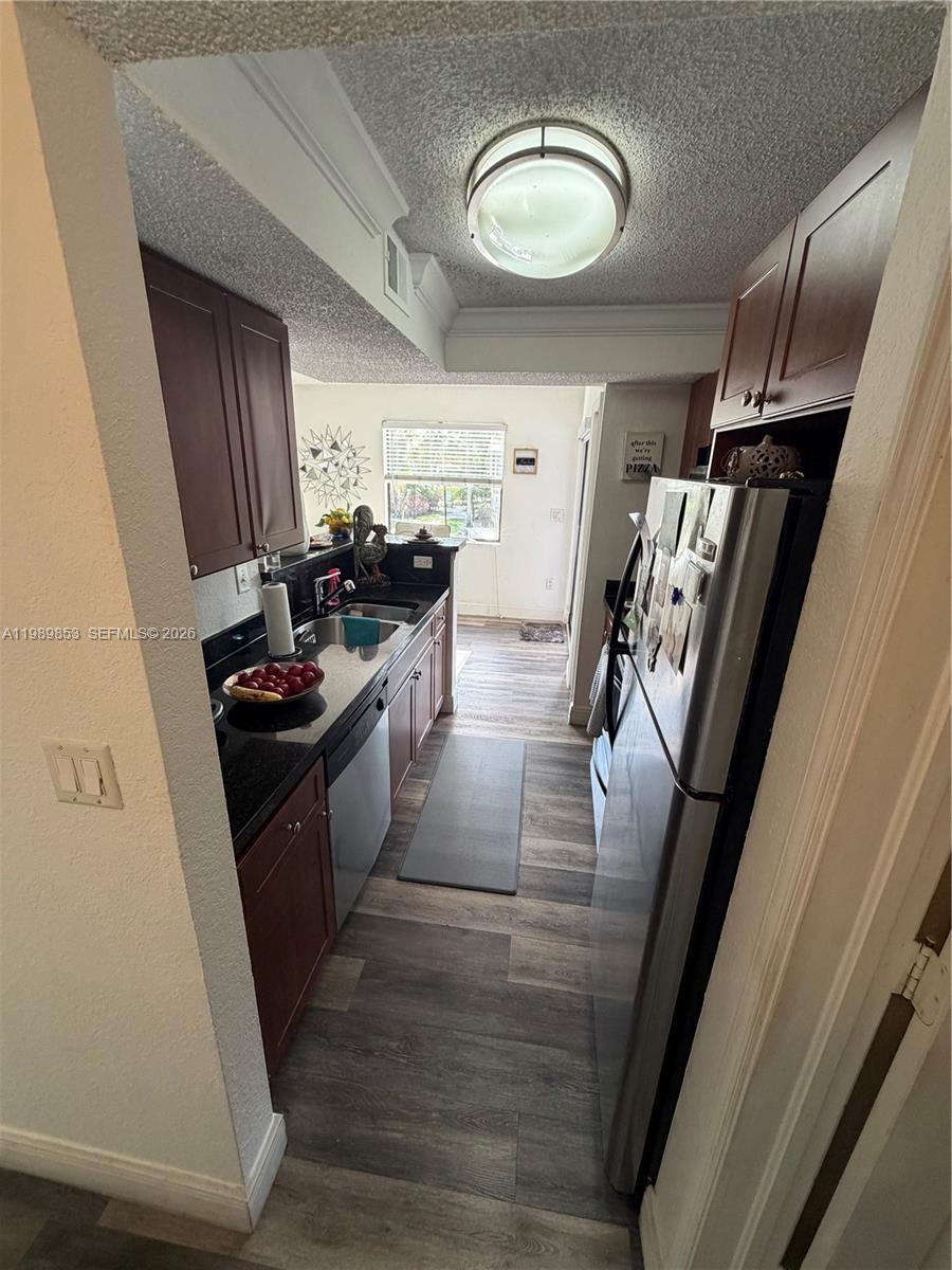 10670 Southwest 156th Place, Unit 308 Miami, FL 33196 - Photo 16 of 21 a kitchen with a sink stove and refrigerator