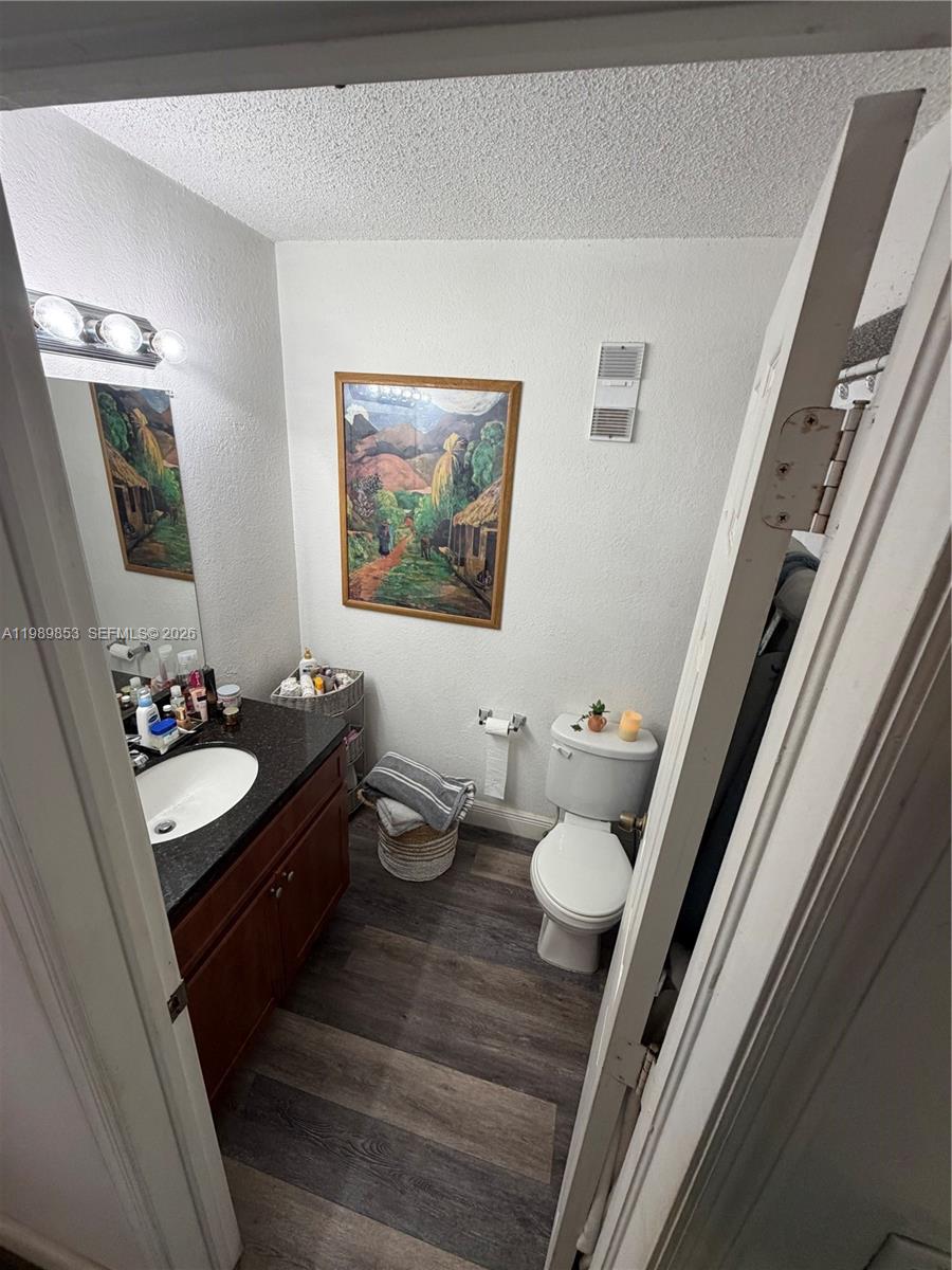 10670 Southwest 156th Place, Unit 308 Miami, FL 33196 - Photo 18 of 21 a bathroom with a granite countertop sink and a mirror