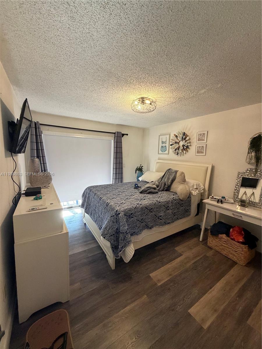 10670 Southwest 156th Place, Unit 308 Miami, FL 33196 - Photo 21 of 21 a bedroom with a bed and a desk