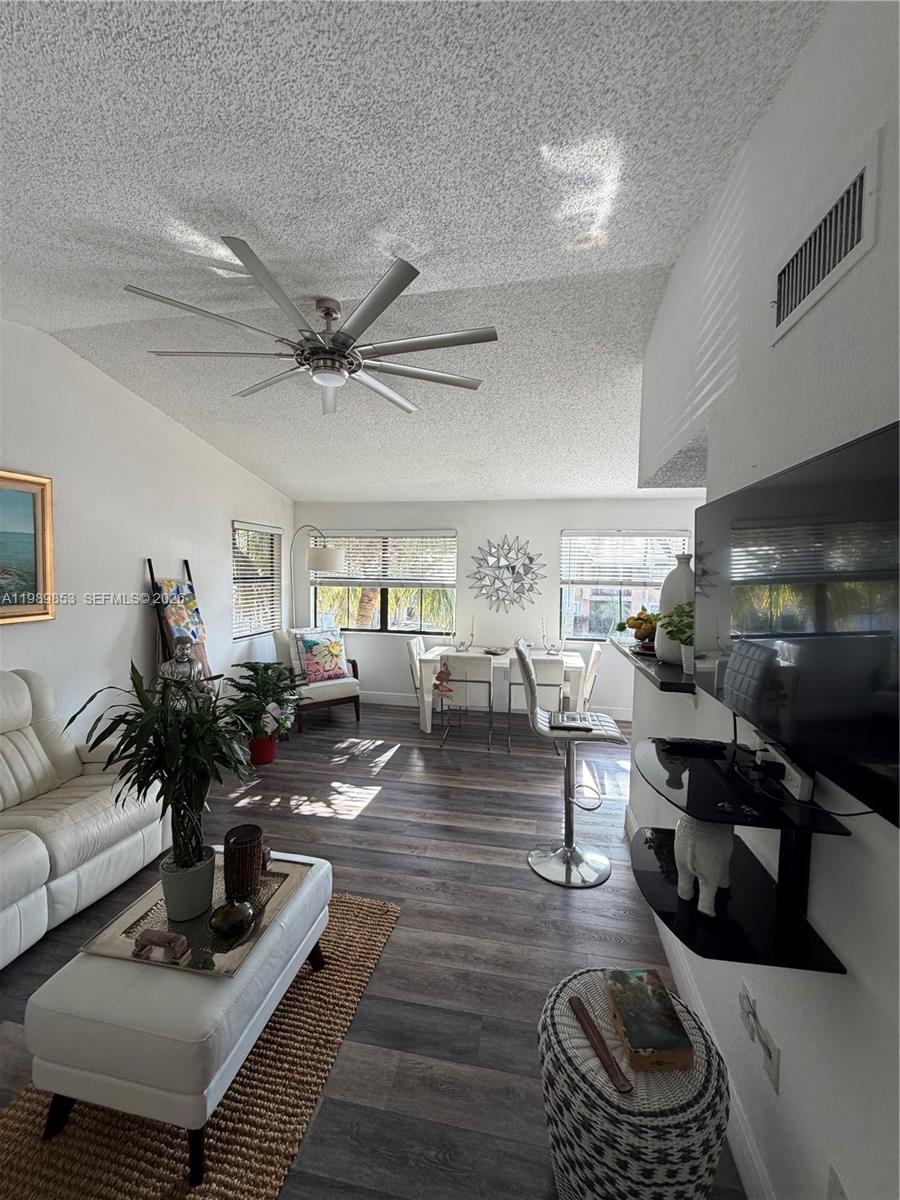 10670 Southwest 156th Place, Unit 308 Miami, FL 33196 - Photo 3 of 21 a living room with furniture and a wooden floor