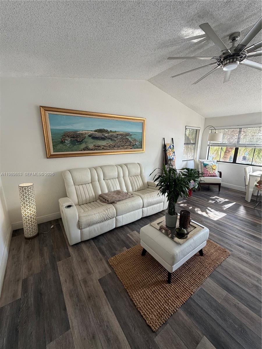 10670 Southwest 156th Place, Unit 308 Miami, FL 33196 - Photo 4 of 21 a living room with furniture and a wooden floor