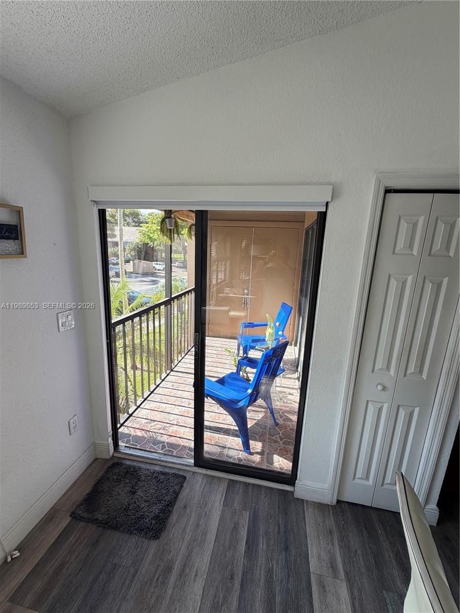 10670 Southwest 156th Place, Unit 308 Miami, FL 33196 - Photo 5 of 21 a view of a hallway with wooden floor and staircase