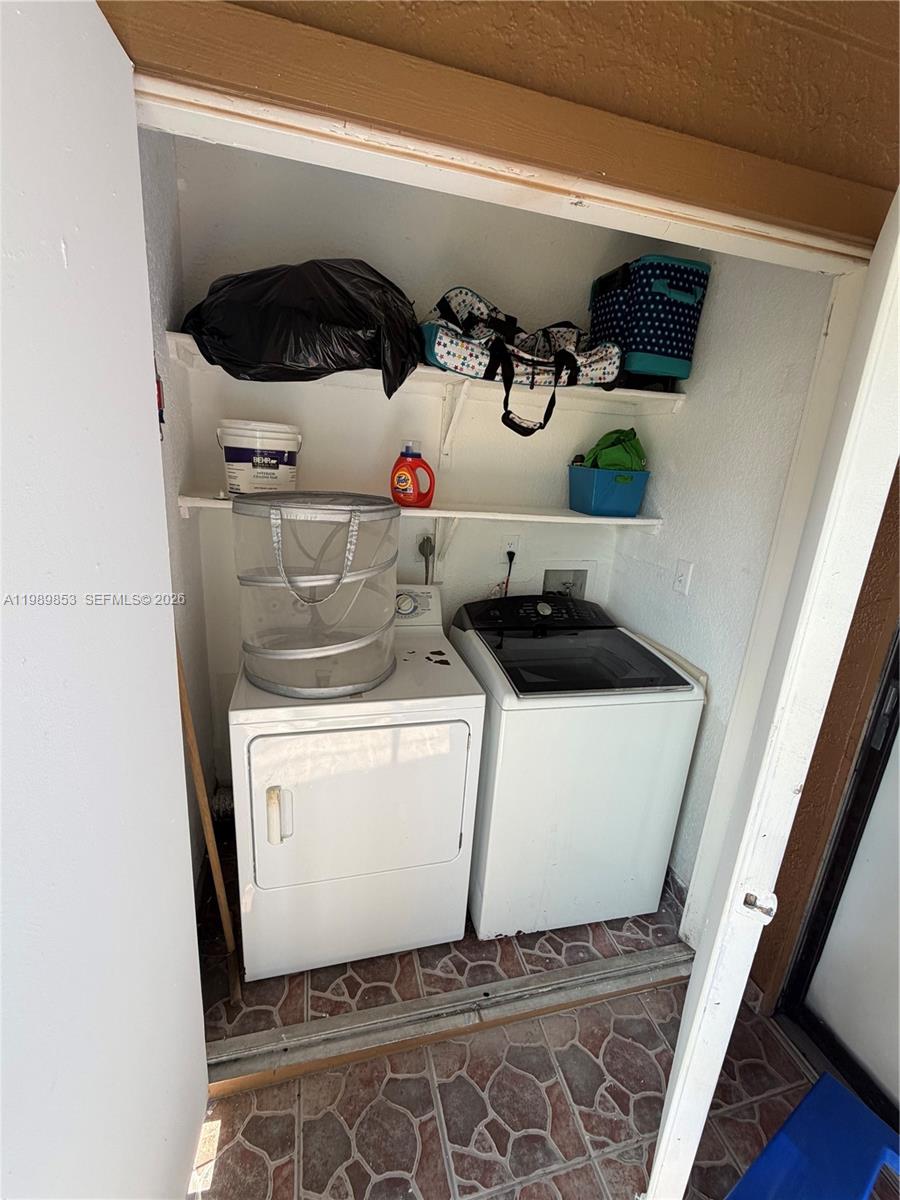 10670 Southwest 156th Place, Unit 308 Miami, FL 33196 - Photo 8 of 21 a utility room with dryer and washer
