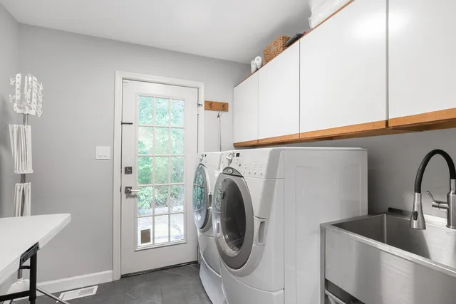 a utility room with sink dryer and washer
