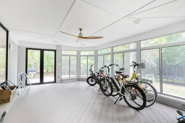 a view of a room with lots of furniture and wooden floor