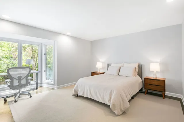 a bedroom with a bed and a table