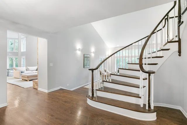 a view of entryway and hall with wooden floor