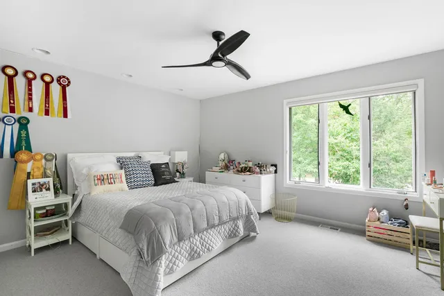 a spacious bedroom with a bed and a window