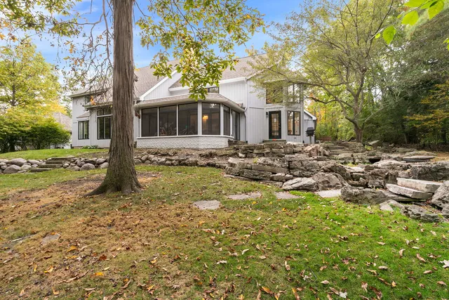 a tree in front of a white house