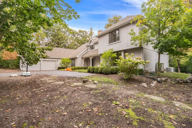 a front view of a house with a yard and a garage