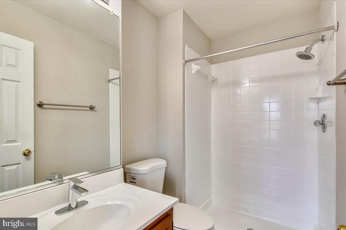 106 Princetown Drive, Unit 5B Frederick, MD 21702 - Photo 14 of 38 a bathroom with a shower curtain a sink and a toilet