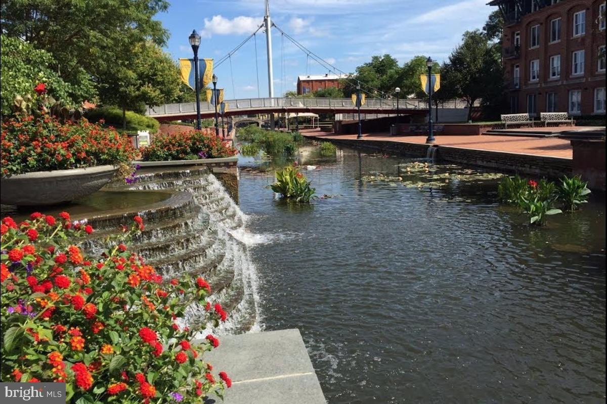 106 Princetown Drive, Unit 5B Frederick, MD 21702 - Photo 26 of 38 a view of swimming pool with outdoor seating and plants