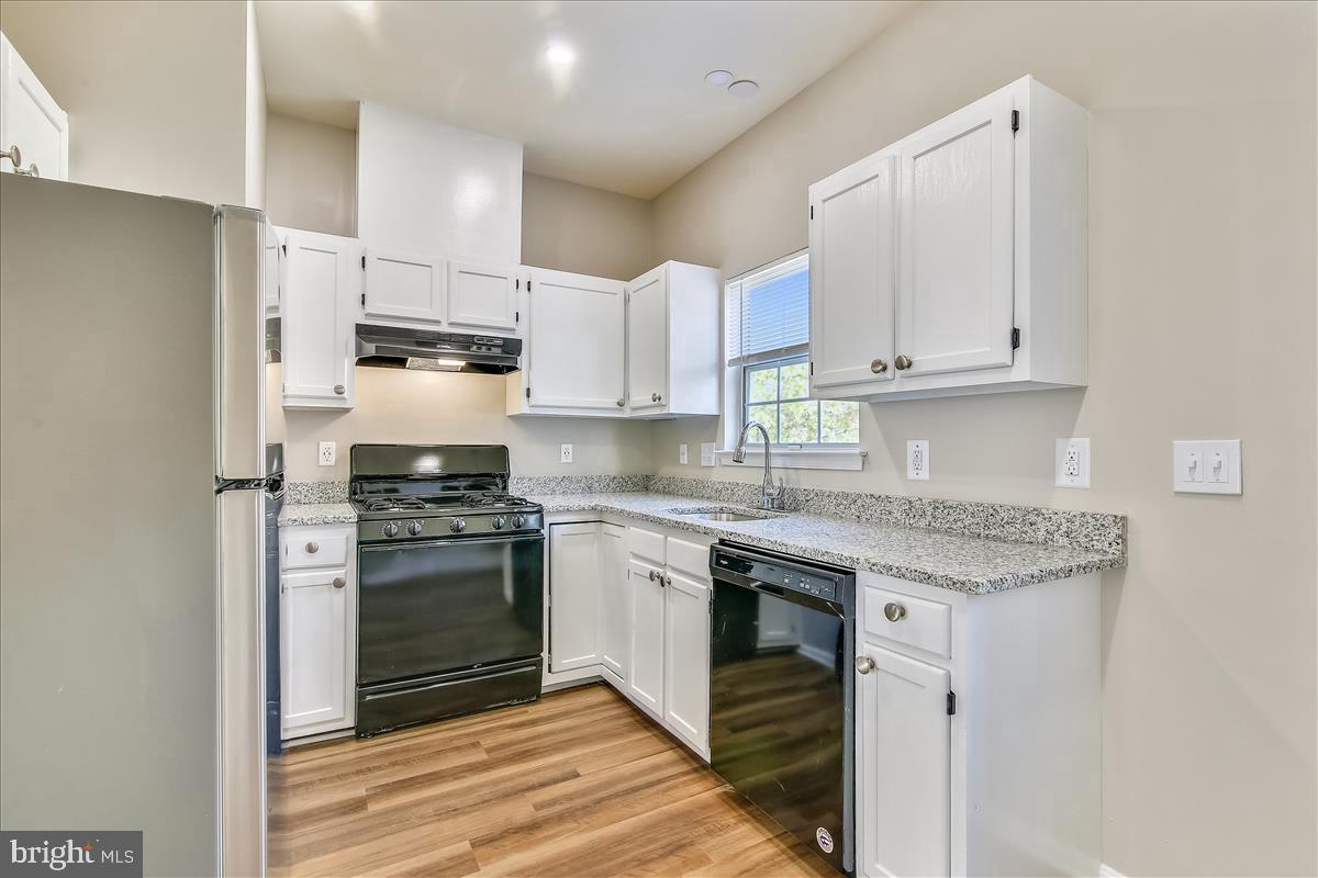 106 Princetown Drive, Unit 5B Frederick, MD 21702 - Photo 4 of 38 a kitchen with stainless steel appliances granite countertop a stove a refrigerator and a sink