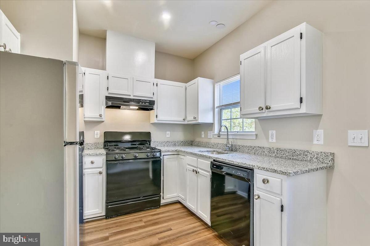 106 Princetown Drive, Unit 5B Frederick, MD 21702 - Photo 5 of 38 a kitchen with stainless steel appliances granite countertop a stove a sink and a refrigerator