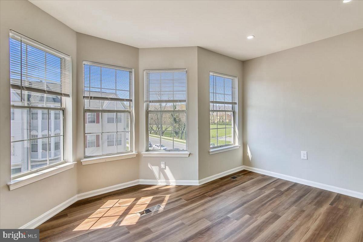 106 Princetown Drive, Unit 5B Frederick, MD 21702 - Photo 8 of 38 a view of an empty room with wooden floor and a window