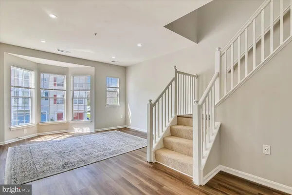 a view of an entryway with wooden floor and door