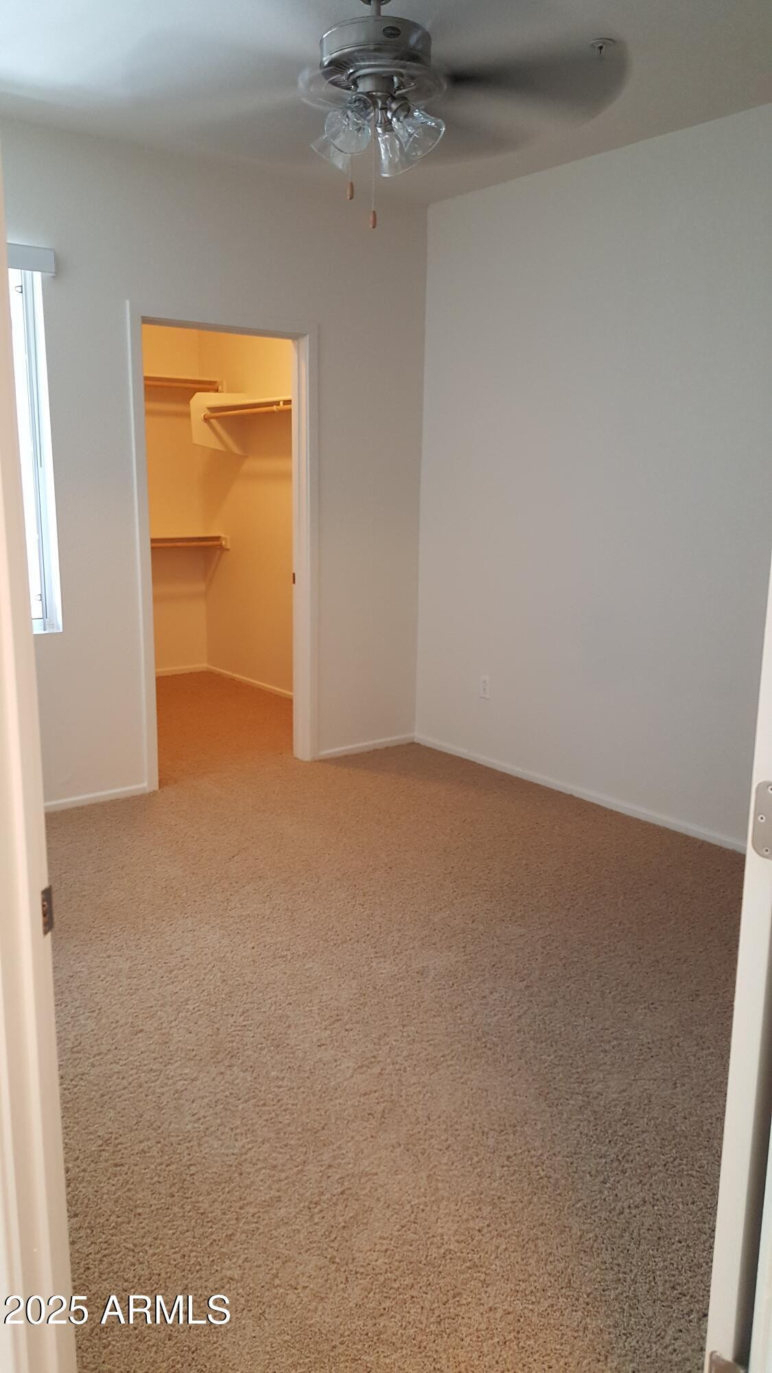 110 West Bell Road, Unit 1 Phoenix, AZ 85023 - Photo 6 of 19 an empty room with a ceiling fan and a window