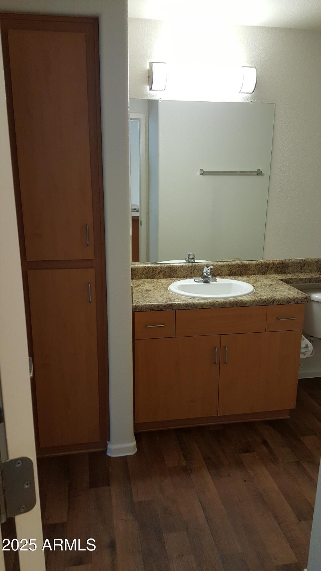 110 West Bell Road, Unit 1 Phoenix, AZ 85023 - Photo 8 of 19 a bathroom with a granite countertop sink and a mirror